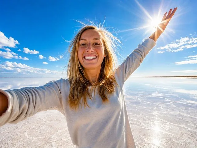 Smiling woman taking a selfie on the flooded Bonneville Salt Flats