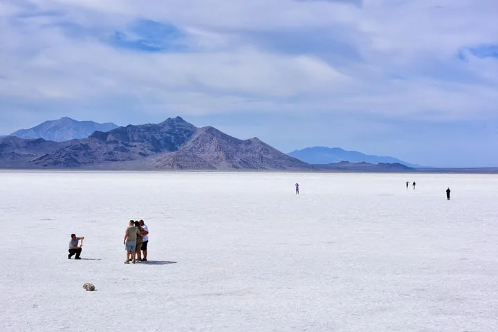 Tourists walking on the vast expanse of Bonneville Salt Flats
